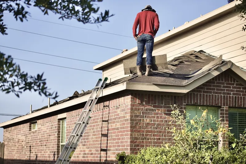 Professional roofer working on a residential roof in Harpswell